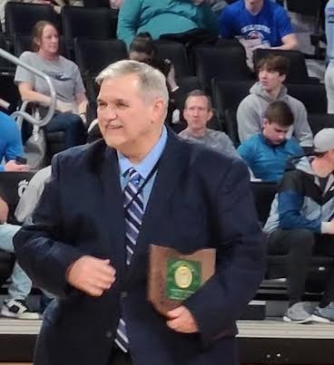 Bill Idle receiving the 2022 OHSAA Media Award on the floor of Fifth Third Arena, Cincinnati.